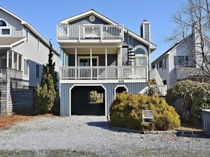 Stunning exterior showcasing the home’s charming beach-style architecture, with plenty of parking and a welcoming entrance.