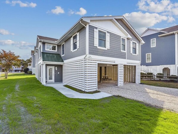 This stunning coastal home features stylish modern renovations, boasting two primary suites and a spacious open living area with a 10' kitchen island, perfect for entertaining near Bethany Beach.