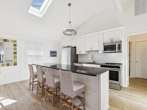 The heart of the home, this renovated kitchen boasts a spacious 10' island that seamlessly connects to the open living area, perfect for entertaining.