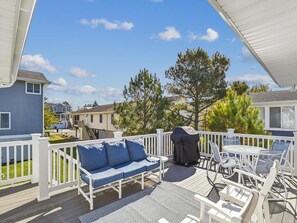 Relax and grill in style on the spacious sun deck, a perfect outdoor retreat for entertaining and soaking up the sun, all while being close to the beach.