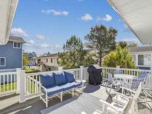 Relax and grill in style on the spacious sun deck, a perfect outdoor retreat for entertaining and soaking up the sun, all while being close to the beach.