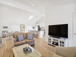 This bright and airy space connects to the kitchen, enhancing the home's flow and making it an entertainer's dream.