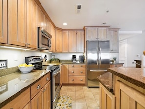 With its sleek finishes and thoughtful design, this kitchen combines modern amenities with a warm, inviting atmosphere, ideal for creating memorable meals and moments.