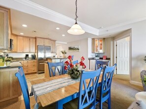 Enjoy modern amenities in the open-concept kitchen and dining area, showcasing stylish cabinetry and a welcoming atmosphere ideal for family gatherings.