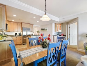 Enjoy modern amenities in the open-concept kitchen and dining area, showcasing stylish cabinetry and a welcoming atmosphere ideal for family gatherings.