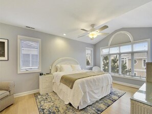 Relax in the serene master suite that boasts natural light and stylish decor, providing a peaceful retreat just steps from the beach.