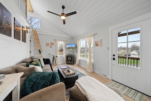 Cozy living room with smart TV, entrance to home.