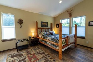 Guest bedroom. Queen bed. TV.  Views to the north out to the barn and horse pasture.