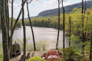 Your private oasis, comprised of terraced garden, outdoor fireplace and lake beyond.
