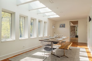 Skylights and wall-to-wall windows make this dining space an absolutely delight.
