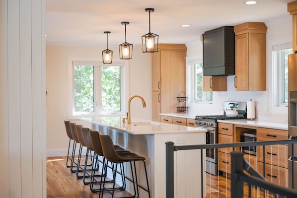 Fully stocked kitchen with gas stove and dishwasher.