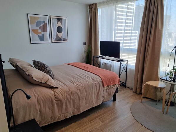 Bright and modern bedroom with a cozy queen bed, stylish decor, and stunning city views. Perfect for a relaxing getaway!