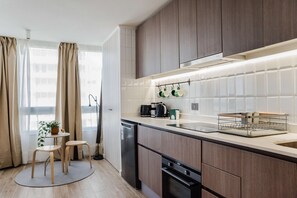 Chic and modern kitchen with natural light and cozy dining nook, perfect for enjoying your morning coffee.
