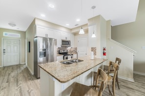 Cook in style with granite counters, sleek stainless appliances, and a cozy breakfast bar
