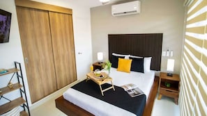 There's a wall-mounted Smart TV, A/C, and ample closet space