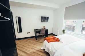 A bright, modern studio designed for comfort—sleep, relax, dine, and work in one beautifully arranged space