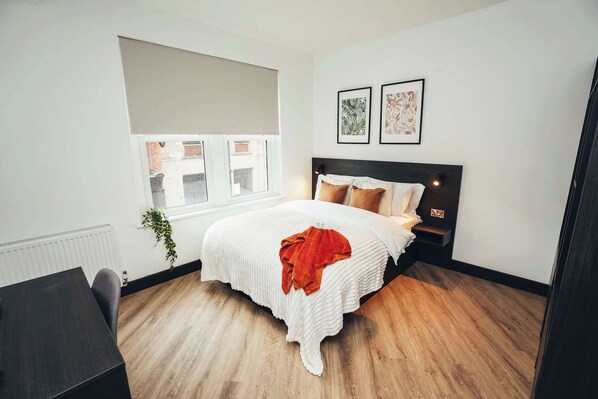 Comfortable bed with fresh linens, soft lighting, and peaceful vibes for a great night’s sleep.