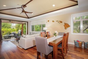 The airy great room brings everyone together for meals, games, or movie nights in true Hawaiian comfort.