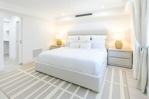 A calming retreat with plush bedding, elegant lighting and walk-in closet.