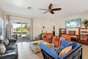 Living room that leads to covered patio and pool