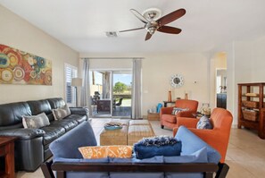 Living room that leads to covered patio and pool