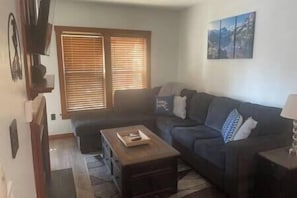 Living Room with Smart TV & Queen Sofabed