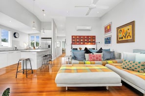 The open plan living and dining space upstairs flows to a large entertainers’ balcony creating a seamless transition with the outdoors.
