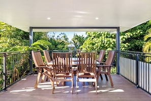 Dine alfresco out on the patio, surrounded by gorgeous tropical greenery.