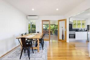 Come together for a meal at home at the large dining table, opening the doors to allow the natural breezes to stream through.
