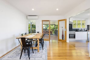 Come together for a meal at home at the large dining table, opening the doors to allow the natural breezes to stream through.