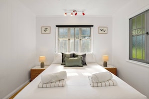 The third bedroom comes with a queen-sized bed, air-conditioning and an open private bathroom.