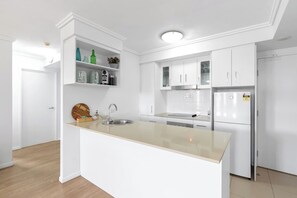 Prepare home-cooked meals in the fully equipped kitchen with an oven, dishwasher, espresso machine and ample kitchen bench.