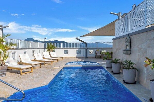 Float above the city in the rooftop shared pool, where calm water and an open skyline create the perfect midday pause.