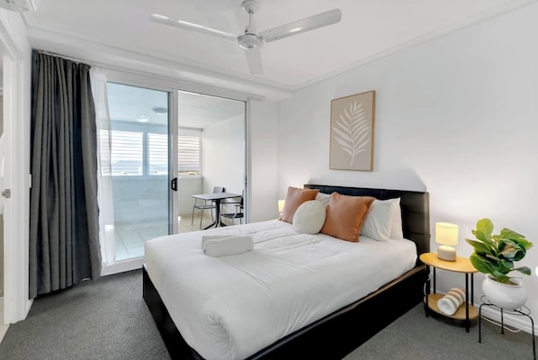 Rest easy in a queen bed surrounded by natural light, with direct access to a private sunroom for extra space and quiet moments.