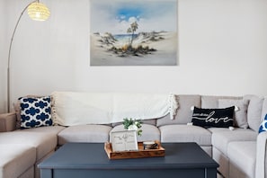 Relax in our cozy living room with access to the pool