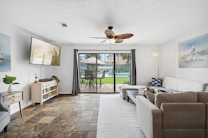 Relax in our cozy living room with access to the pool