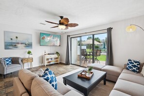 Relax in our cozy living room with access to the pool
