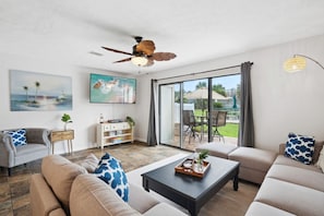 Relax in our cozy living room with access to the pool