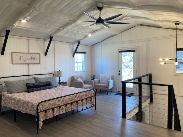 SECOND FLOOR: King bed, sitting area, exterior door to second story deck.