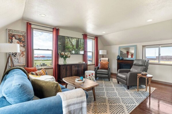 Living room with sleeper sofa, unobstructed views of the water and mountains