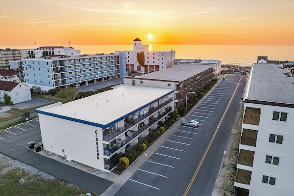Golden-hour drone shot of your beachside building—just steps from the sand.