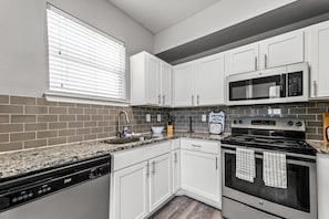 As you open the kitchen, you discover an assortment of coffee pods, and sugar, ensuring you have everything you need for a perfect morning or afternoon pick-me-up.
