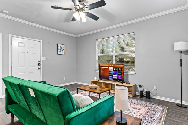 The living room is filled with natural light, creating a bright and welcoming space that invites relaxation.