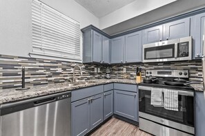 You can almost hear the sizzle of ingredients as you cook in the well-equipped kitchen, where every detail is designed for convenience.