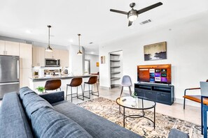 You feel at home as you settle into the living room, where the inviting atmosphere is perfect for lounging or entertaining.