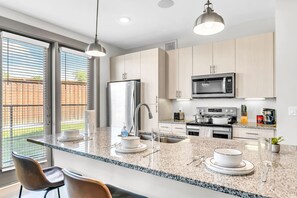The dining room is bathed in natural light, creating a bright and inviting space where every meal feels special.