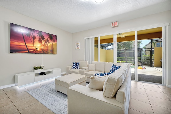 Cozy living room with 85" TV and Mickey Mouse-themed décor