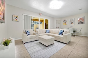 Another view of the living room with plush seating and Disney charm