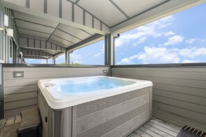 Unit 2: Covered private rooftop deck with a hot tub, lounge areas, fire pit, and access to the second living area. (4th Floor)