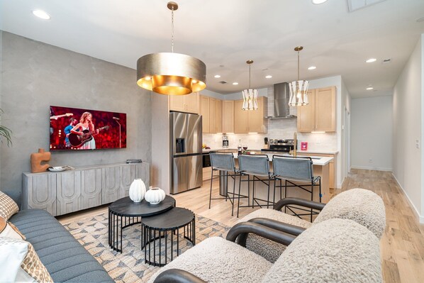 Unit 1: Living Area with an open layout, cozy armchairs, a comfy sofa, and a Smart TV for easy relaxation. (2nd Floor)